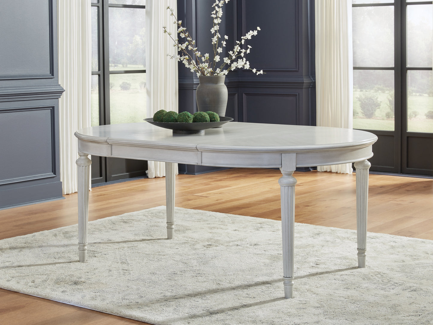 Bradenton Furniture Outlet - Ashley Furniture - Montelaine Dining Room - Oval Dining Room EXT Table / Antique White - D795-35