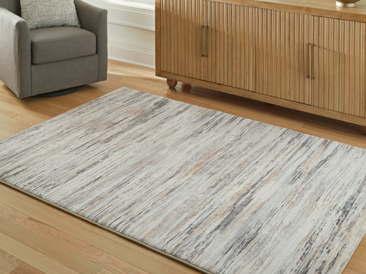 Bradenton Furniture Outlet - Ashley Furniture - Nace Rug - 5' x 7' Area Rug / Gray/Brown/White - R407472