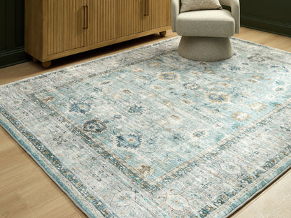 Bradenton Furniture Outlet - Ashley Furniture - Ladstoney Rug - 7'6" x 9'6" Area Rug / Teal/Beige/Ochre - R407501