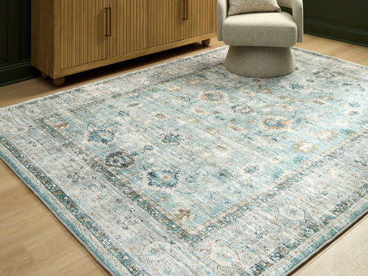 Bradenton Furniture Outlet - Ashley Furniture - Ladstoney Rug - 7'6" x 9'6" Area Rug / Teal/Beige/Ochre - R407501
